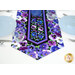 A close up on one end of the table runner, showing details on the fabrics and binding in contrast with the white table.