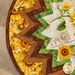 A stylized close up on the topper, focusing on the folded point fabrics, demonstrating print colors and details.