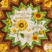 A top down close up of the center of the topper, demonstrating fabric color harmony and the main fabric, a cream newsprint themed fabric with yellow sunflowers.