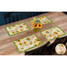 The completed placemats at four table settings, staged with coordinating flowers.