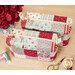 A top down shot of the two completed Mini-Charm Bags, staged on a wooden table with coordinating notions and flowers.
