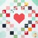 A head-on shot of a red patchwork heart and the surrounding lattice.