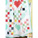 A close shot of the quilt artfully draped over a white armoire, demonstrating drape and design.