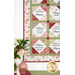 A shot of the lower left corner of the quilt, staged above a green armoire set with coordinating décor.