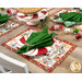 A shot of coordinating cloth napkins, tableware, and decor staged on and around the placemats to demonstrate usage.