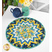 The completed Point of View Folded Star Table Topper colored in yellow, aqua, and blue floral fabrics from the Sunlit Serenade collection. The topper is staged on a white table with coordinating summer-themed decor and flowers.