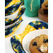A close up shot of a blueberry muffin in a bowl in the bowl cozy.