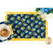 A top-down shot of a place setting with the coordinating bowl cozy on the placemat, showing function.