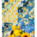 A shot of the bottom corner of the diamond on the quilt, with coordinating yellow and blue florals in the foreground.