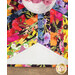 A close-up, top down shot of the topper, topped with a white vase of decorative flowers in coordinating colors, showing details on the flower themed print.