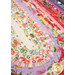 A super close up on the Jelly Roll Rug demonstrating print and color details on the fabrics.