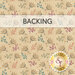 A tan swatch of fabric with a tossed leaf motif in beige, camel, teal, purple, and coral. A banner at the top reads 