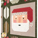Quilt featuring a festive Santa face and a reindeer, with floral and geometric patterns in the background.