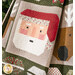 Quilt featuring a patchwork Santa Claus face on a festive background with holiday motifs.