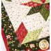 A super close up on a corner of the runner, showcasing the floral fabrics and demonstrating piecing, stitching, border, and binding details.