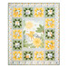 The completed Sunny Safari Patchwork Quilt colored in green, white, and yellow fabrics, isolated on a white background.