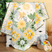A shot of the quilt artfully draped over a white armoire to show movement, staged with coordinating baby décor.