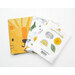 A shot of the folded fabrics and instructions from the kit fanned out on a white tabletop.