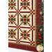 A stylized shot of the quilt, demonstrating the patchwork layout as coordinating decor peek into frame from the right side.