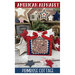 Front of the pattern showing the completed design in a red frame and staged with coordinating decor.