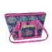Colorful patterned tote bag in pink, green, and blue with a front zip pocket and sturdy straps.