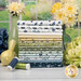 A stack of the fabrics included in the Friendship Garden collection, with flowers and a window and vases and a birds and thread.
