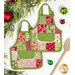 The two completed hot pads colored in bright green, red, and cream fabrics, from the Buon Natale collection, staged on a clean white background with coordinating holiday decor and a wooden spatula.
