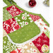 A closer look at one of the apron themed hot pads, demonstrating print colors and details as well as details on the white lace trim of the pocket.