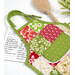 A top down shot of one of the completed hot pads, staged with coordinating decor, a recipe card, and a wooden spoon.