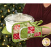 A model demonstrates the use of the Apron Hot Pads, holding a white casserole dish.