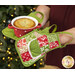 A model demonstrates the use of the Apron Hot Pads, holding a small ramekin with a pie inside it.