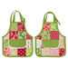 The two completed hot pads colored in bright green, red, and cream fabrics, from the Buon Natale collection, isolated on a clean white background.