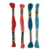 A shot of four skeins of embroidery floss in red, burgundy, teal and blue, isolated on a white background.