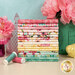 A stack of the fabrics included in the Peony Blossoms Fat Quarter Bundle, with flower and jars and a bird and thread.