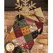 A close up shot of the top of the stocking, where a golden snowflake ornament and gift card box peek out of the opening at the top.