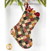 A full-sized shot of one of the tiny stockings hung from a string with small ornaments poking out from the top.
