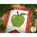 A close up on the green apple block, framed by a decorative leafy garland.