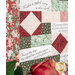 A close up on the quilt, highlighting verse panels and the patchwork piecing.