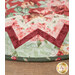 A super close up view of the outer edge of the topper, showcasing fabric, prairie point, binding, and stitching details.