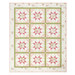 A shot of the completed quilt colored in pink, green, and white floral fabrics from the Shades of Romance collection, isolated on a white background.