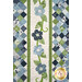 A head on shot of the appliqué flowers and pieced center, showcasing the laser shapes and fabric piecing.