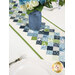 A shot of the bonus runner staged on a set white table underneath a blue vase of coordinating florals.
