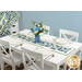 A shot of the bonus runner staged on a set white table underneath a blue vase of coordinating florals.