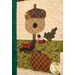 A super close up on an appliqué acorn birdhouse, pumpkin, and bird, demonstrating fabric and topstitching details. 
