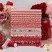 A stack of fabrics included in the Aunt Grace Loves U collection with white, red, and pink fabrics with a Valentine's Day theme, with flowers and jars and buttons and thread.