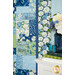 A stylized close up on the patchwork of the quilt, demonstrating color and fabric details; coordinating decor peeks in from the right side of the frame.