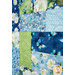 A stylized close up on the patchwork of the quilt, demonstrating color and fabric details.