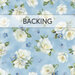 Light blue fabric swatch featuring tossed white flowers and blue small flowers. A transparent banner at the top reads 