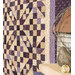 A stylized close up on the quilt, taken at a slight angle; coordinating deco, a bird and birdhouse, peek into frame from the lower right frame.
