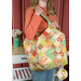 A model holds the Mondo bag over their shoulder, demonstrating size and scale of the bag.